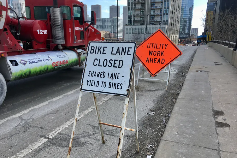 "Bike Lane Closed" and "Utility Work Ahead" signs on Chicago bike lane